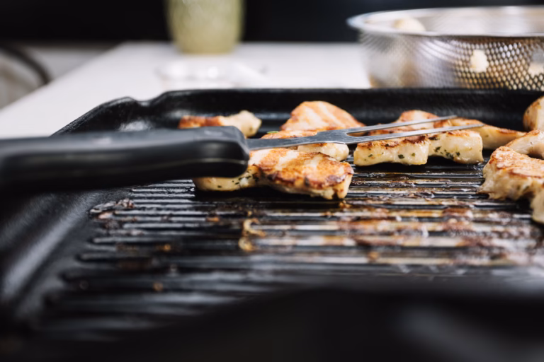 Grilled chicken on a pan, illustrating electric smoker cooking times.